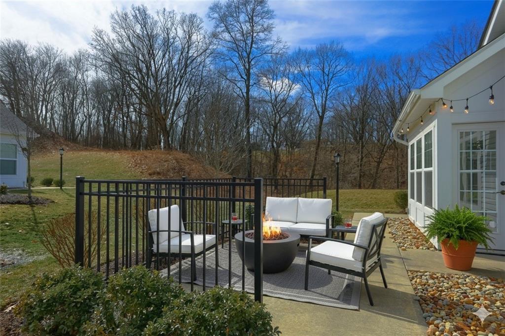 705 Spring Valley Drive Zelienople, PA 16063 - Photo 9 of 34 a view of a patio with couches table and chairs and potted plants