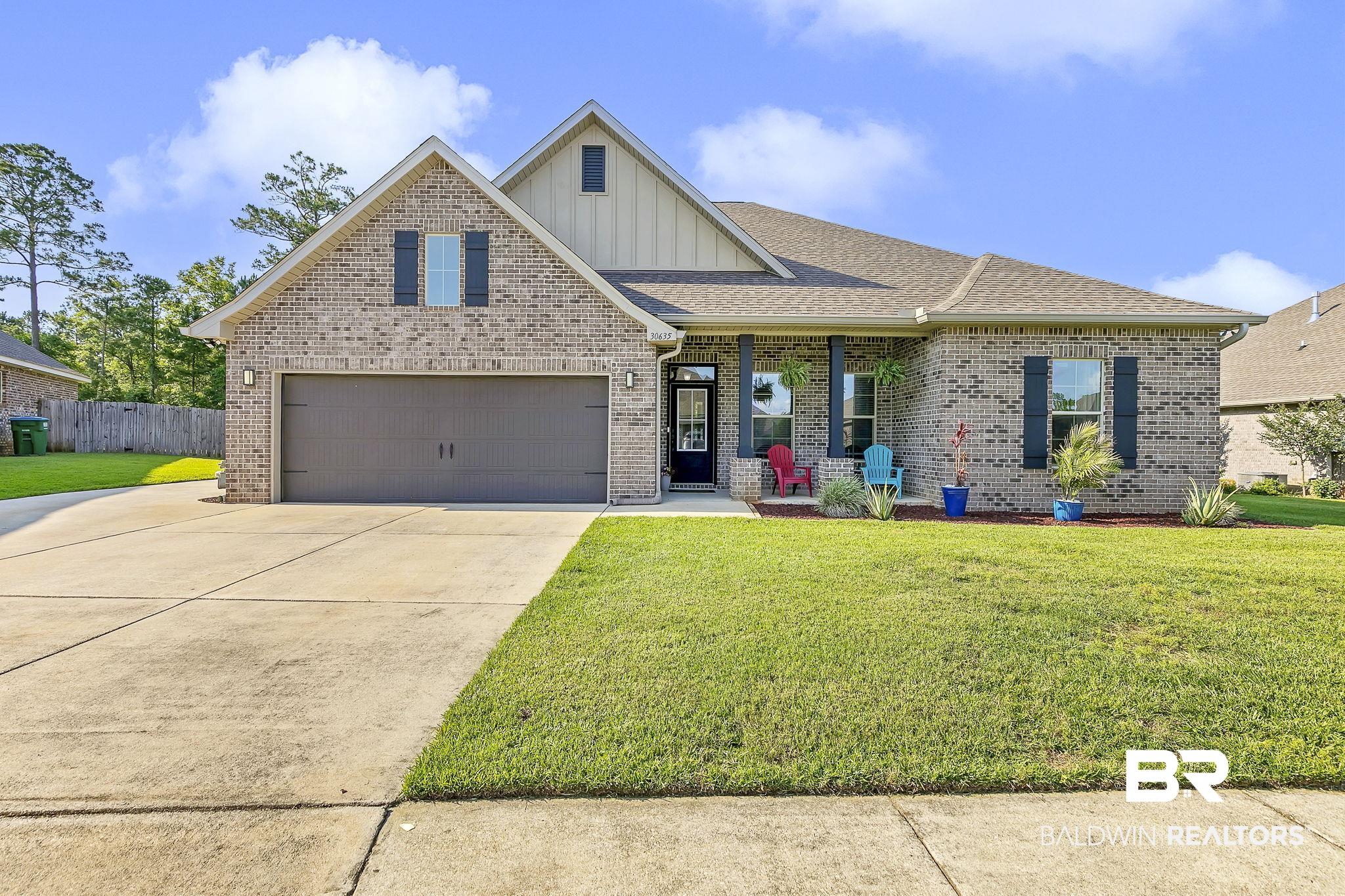 30635 Drayton Court Daphne, AL 36527 - Photo 1 of 51 View of front of house featuring board and batten siding, concrete driveway, brick siding, a shingled roof, and an attached garage