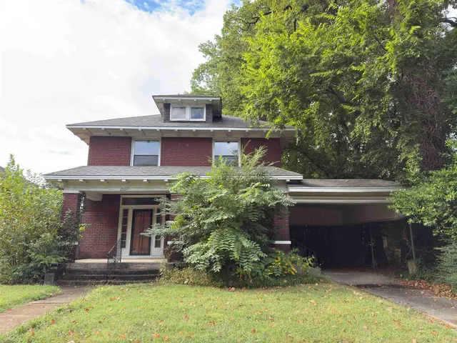 front view of a house with a garden