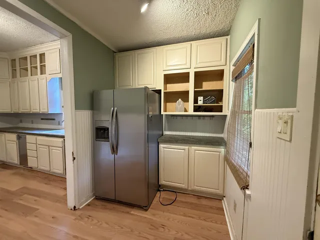 a kitchen with stainless steel appliances a refrigerator and a stove top oven