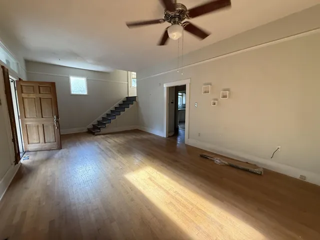 wooden floor in an empty room with a window