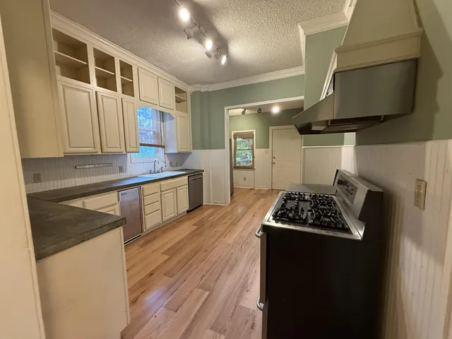 a kitchen with stainless steel appliances a stove a sink and a refrigerator