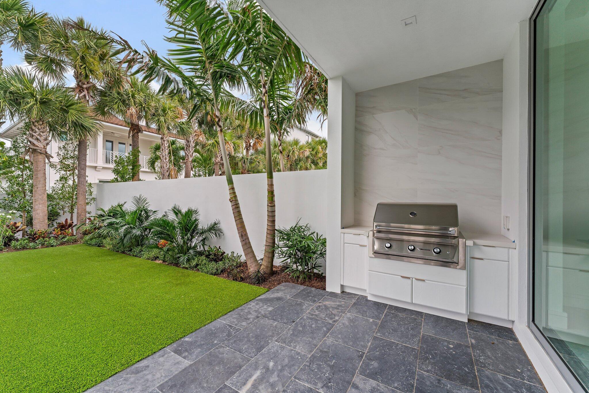 423 Ocean One Lane Juno Beach, FL 33408 - Photo 11 of 58 a kitchen with a stove and a potted plant