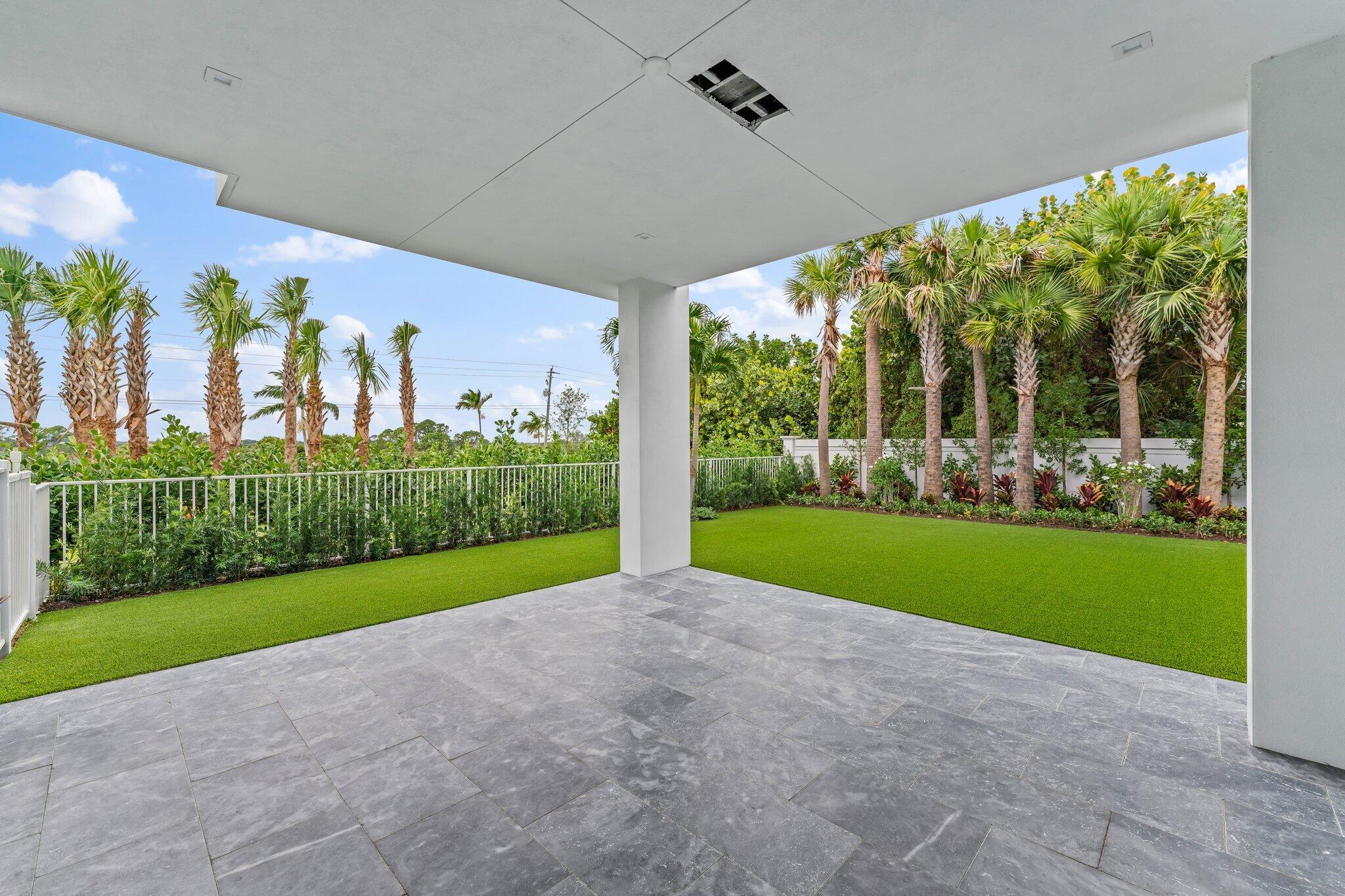 423 Ocean One Lane Juno Beach, FL 33408 - Photo 12 of 58 a view of a garden with plants and large tree