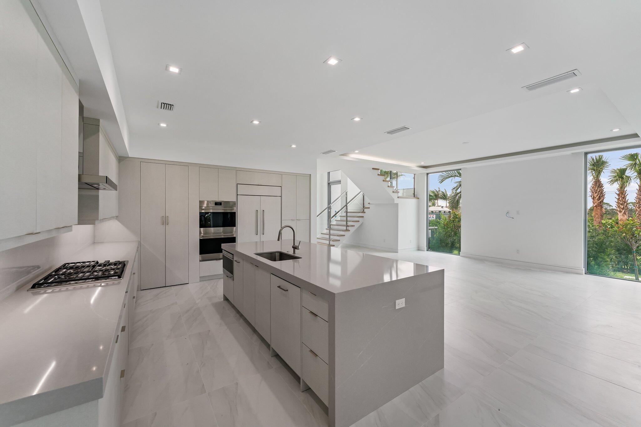 423 Ocean One Lane Juno Beach, FL 33408 - Photo 18 of 58 a kitchen with stainless steel appliances kitchen island sink refrigerator and stove