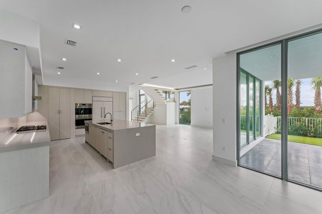 a bathroom with a toilet a sink a mirror and vanity
