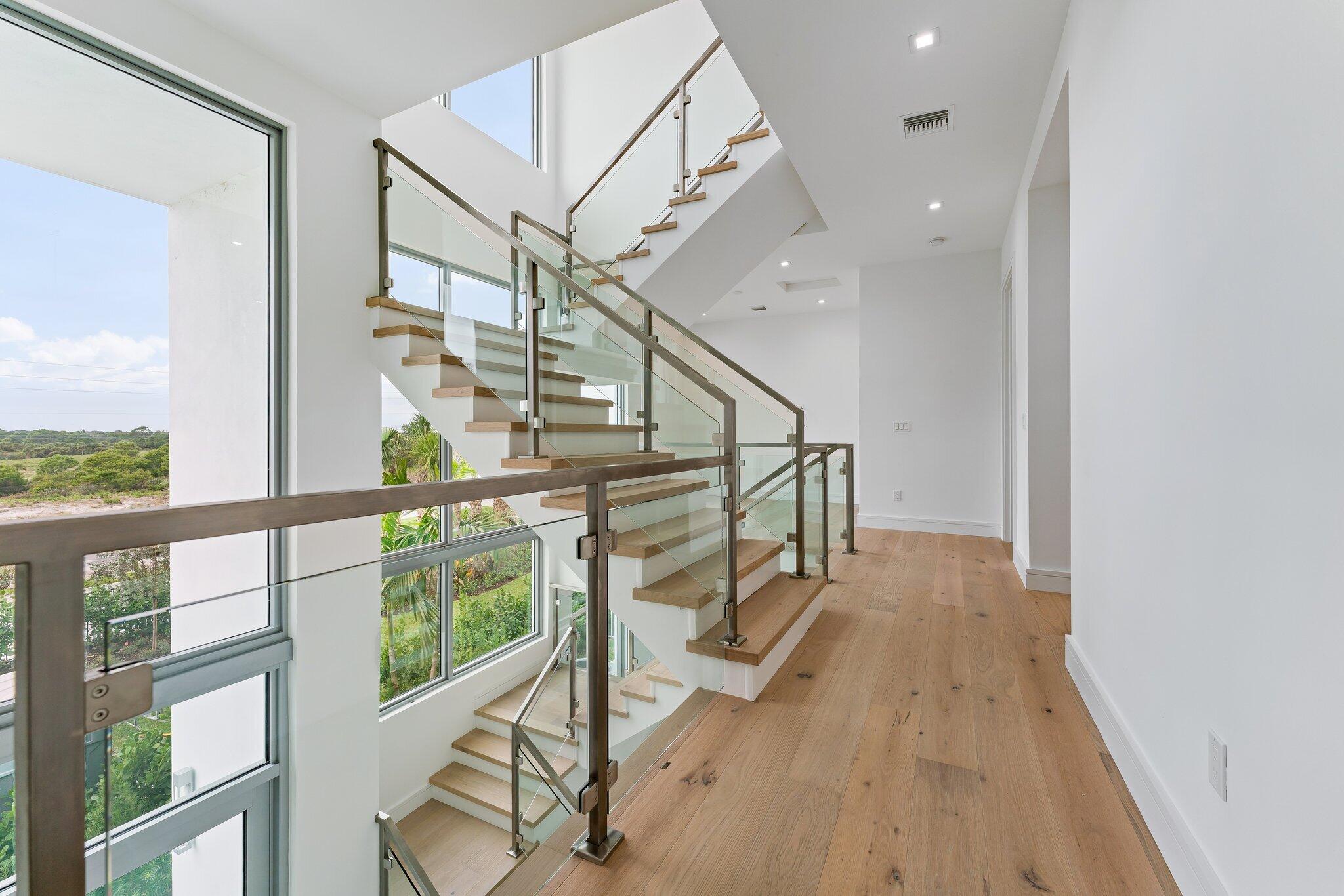 423 Ocean One Lane Juno Beach, FL 33408 - Photo 27 of 58 a view of entryway with wooden floor and stairs