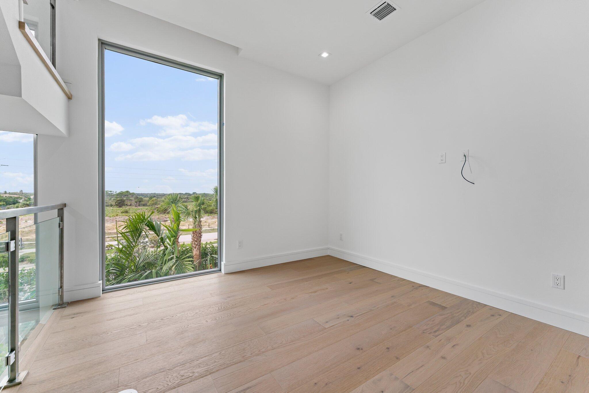 423 Ocean One Lane Juno Beach, FL 33408 - Photo 30 of 58 a view of a room with wooden floor and a window