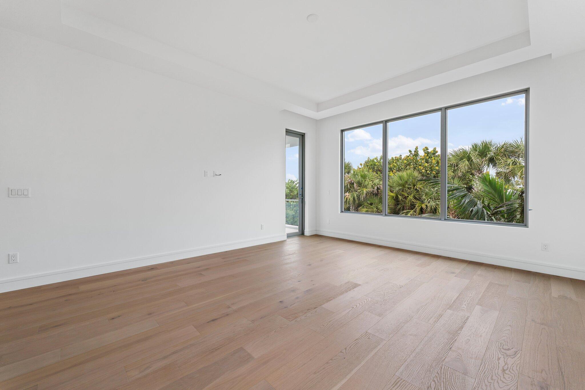 423 Ocean One Lane Juno Beach, FL 33408 - Photo 32 of 58 a view of an empty room with wooden floor and a window
