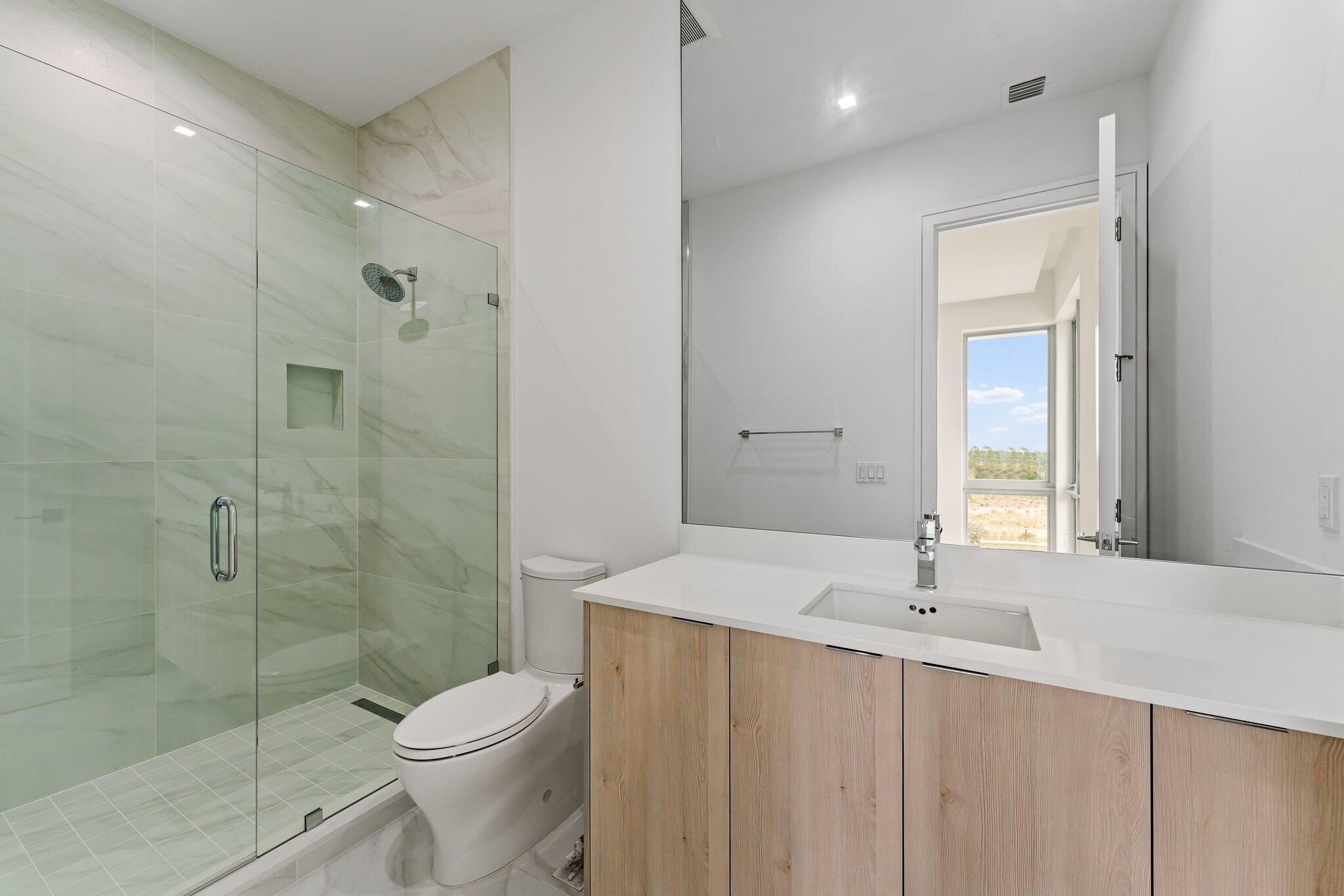 423 Ocean One Lane Juno Beach, FL 33408 - Photo 42 of 58 a bathroom with a sink a toilet and shower