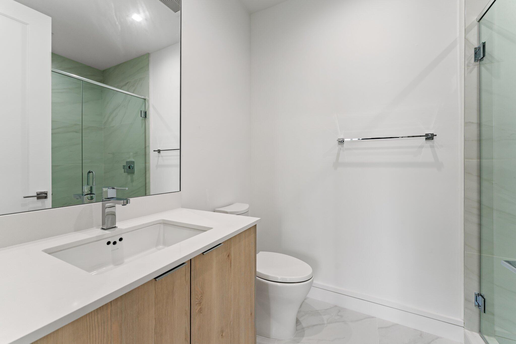 423 Ocean One Lane Juno Beach, FL 33408 - Photo 45 of 58 a bathroom with a sink a toilet and shower