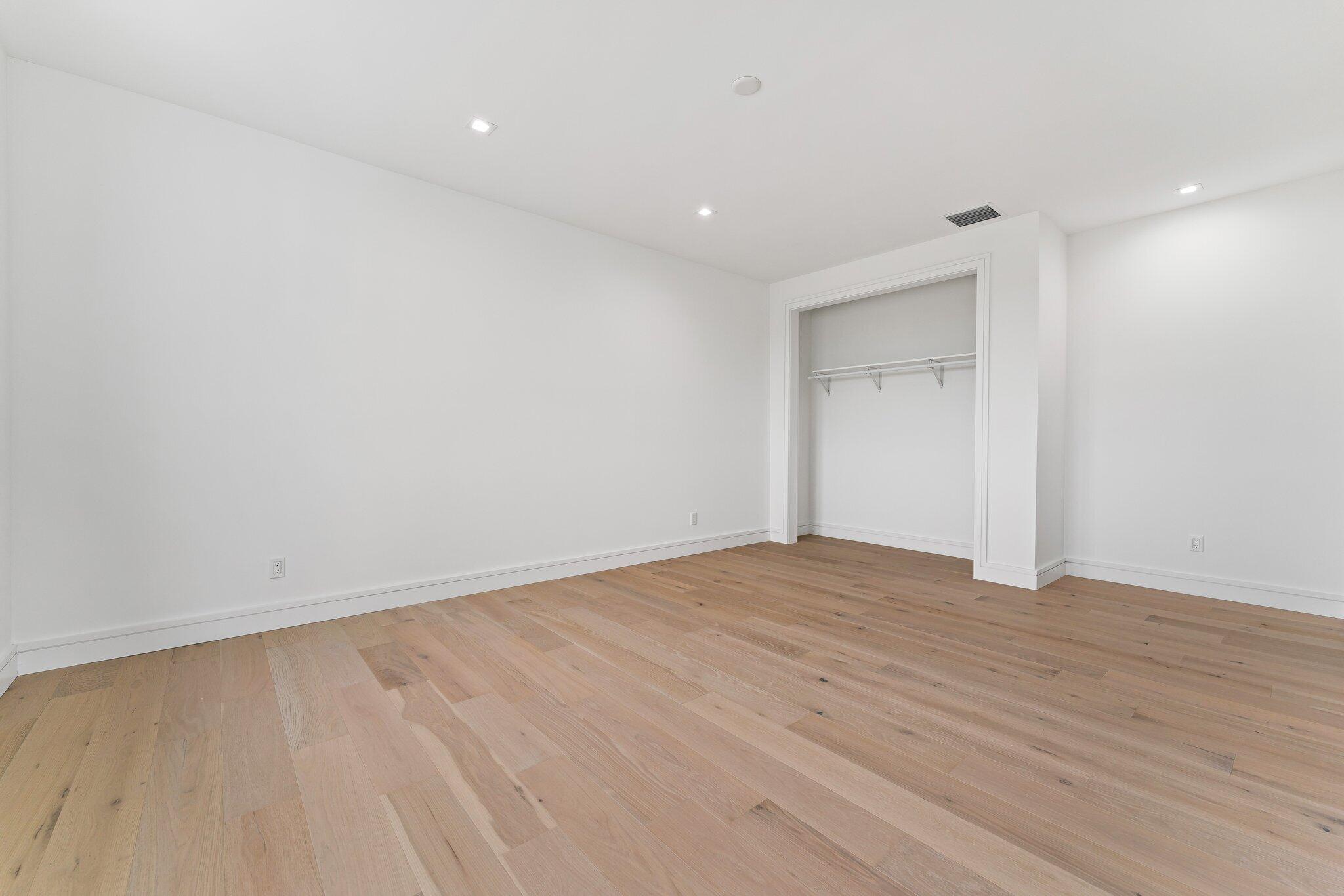 423 Ocean One Lane Juno Beach, FL 33408 - Photo 48 of 58 a view of an empty room with wooden floor and a window