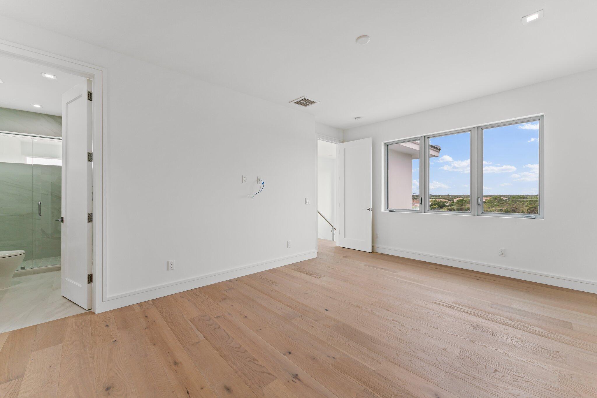 423 Ocean One Lane Juno Beach, FL 33408 - Photo 49 of 58 wooden floor in an empty room with a window