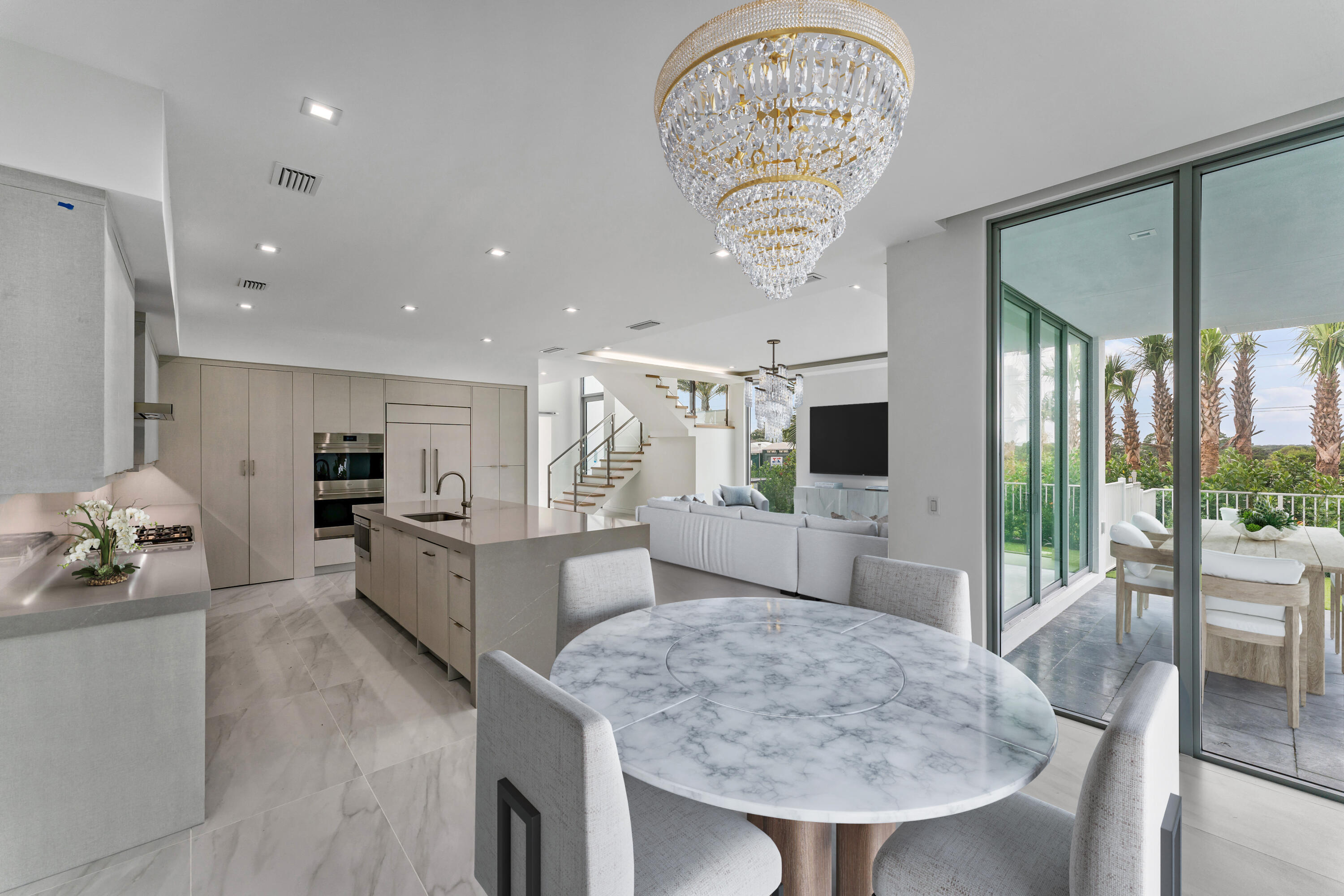 423 Ocean One Lane Juno Beach, FL 33408 - Photo 5 of 58 a large kitchen with a table and chairs in it