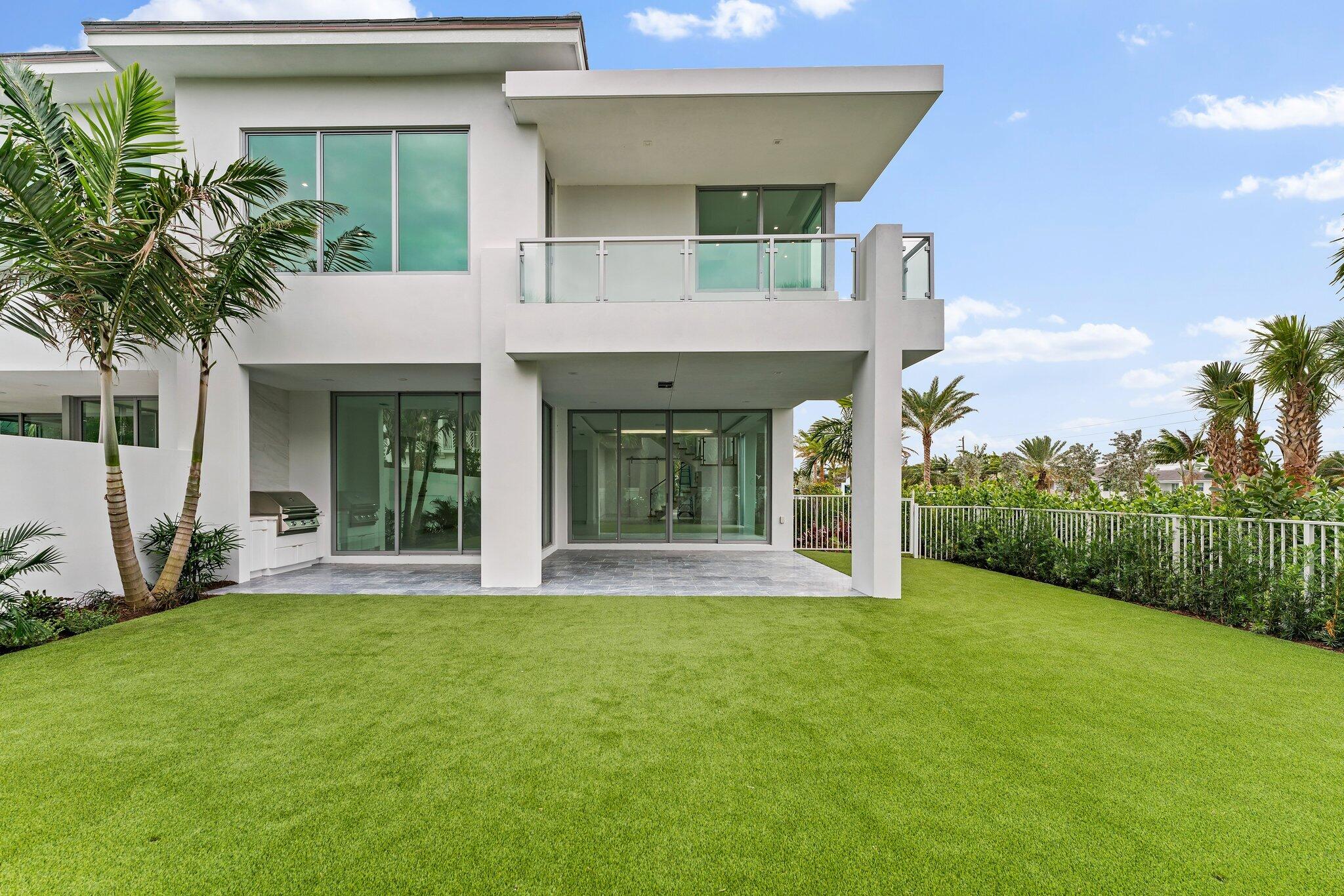 423 Ocean One Lane Juno Beach, FL 33408 - Photo 52 of 58 a view of a house with porch and garden