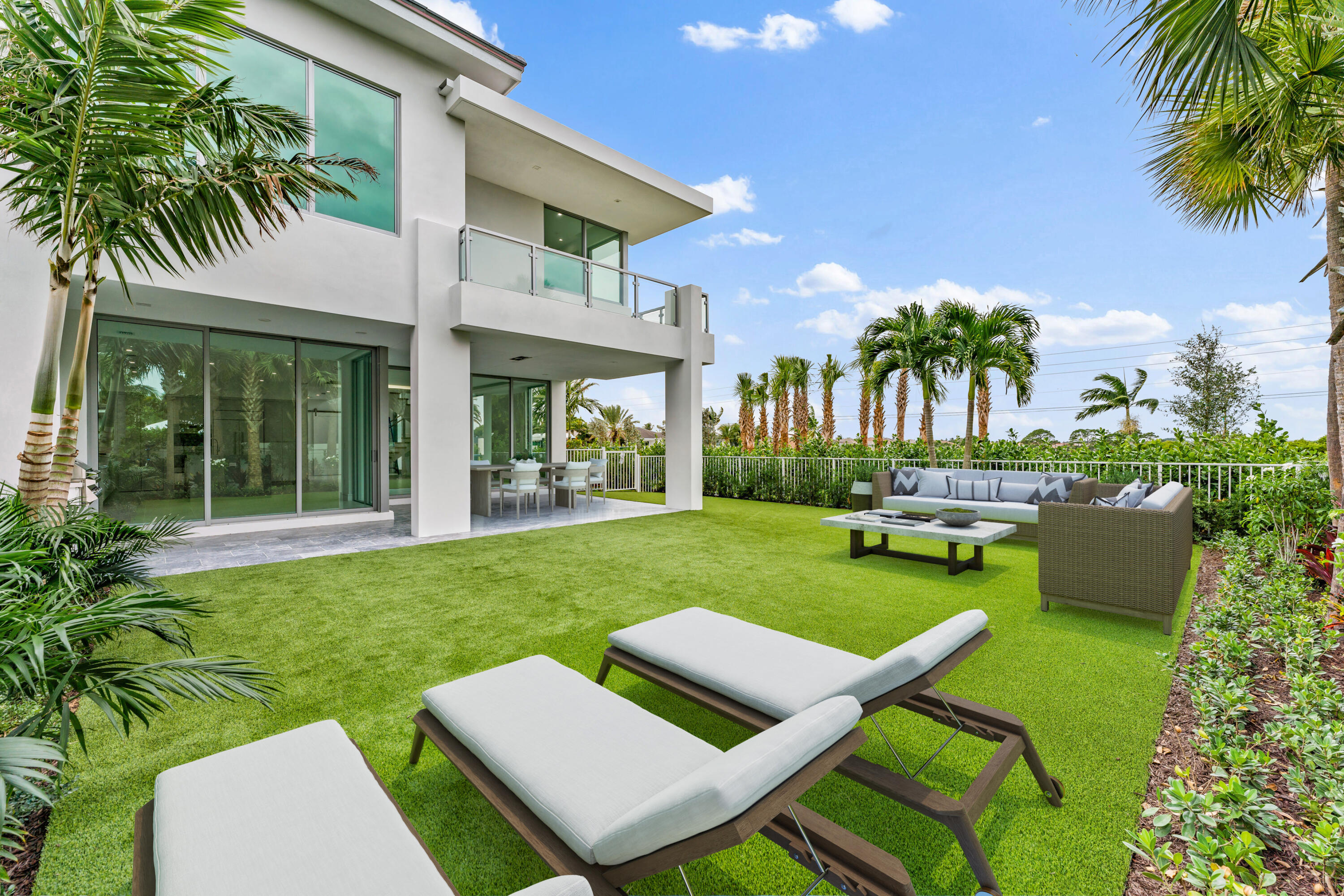 423 Ocean One Lane Juno Beach, FL 33408 - Photo 8 of 58 a view of a backyard with couches plants and large tree