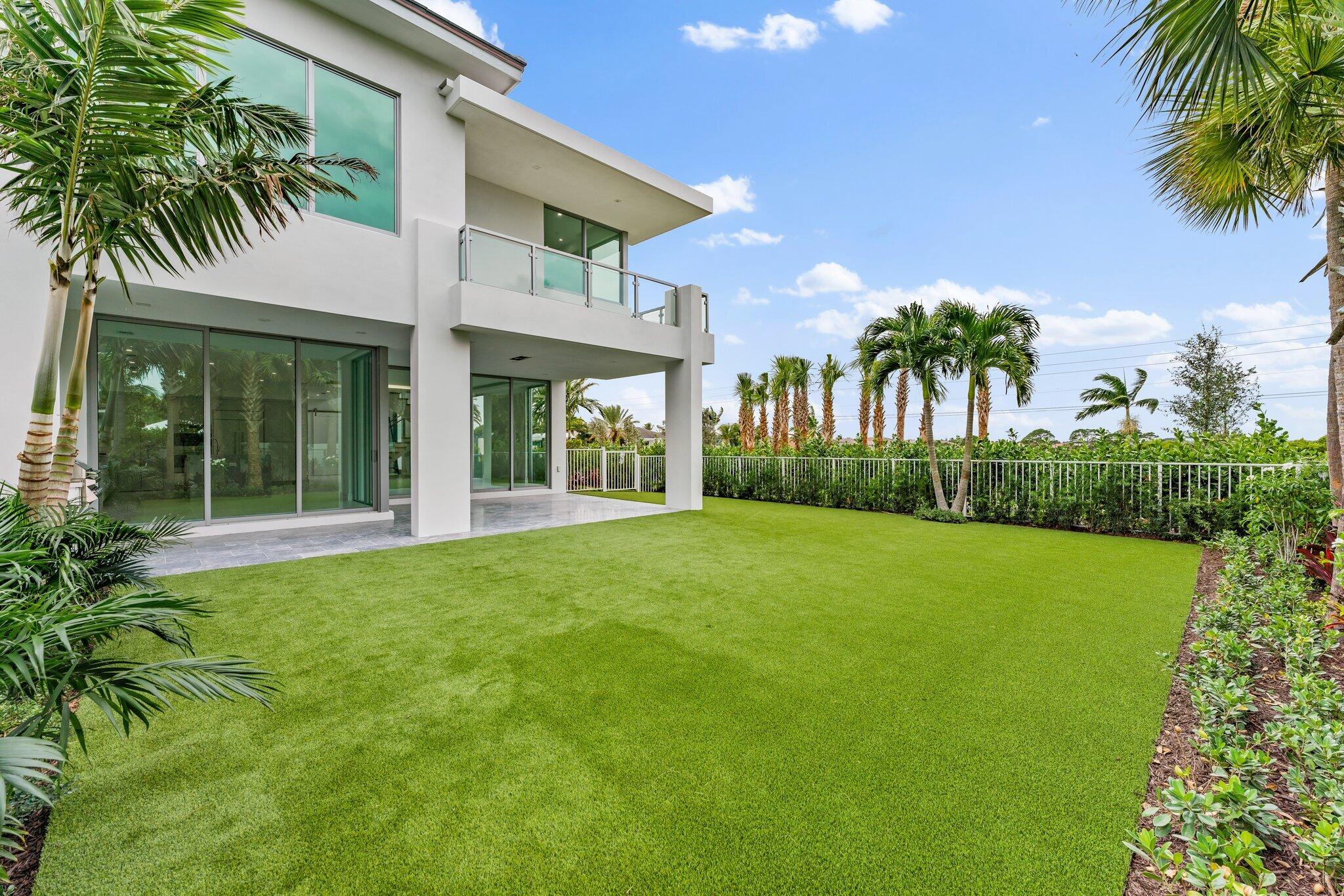423 Ocean One Lane Juno Beach, FL 33408 - Photo 9 of 58 front view of a house with a garden