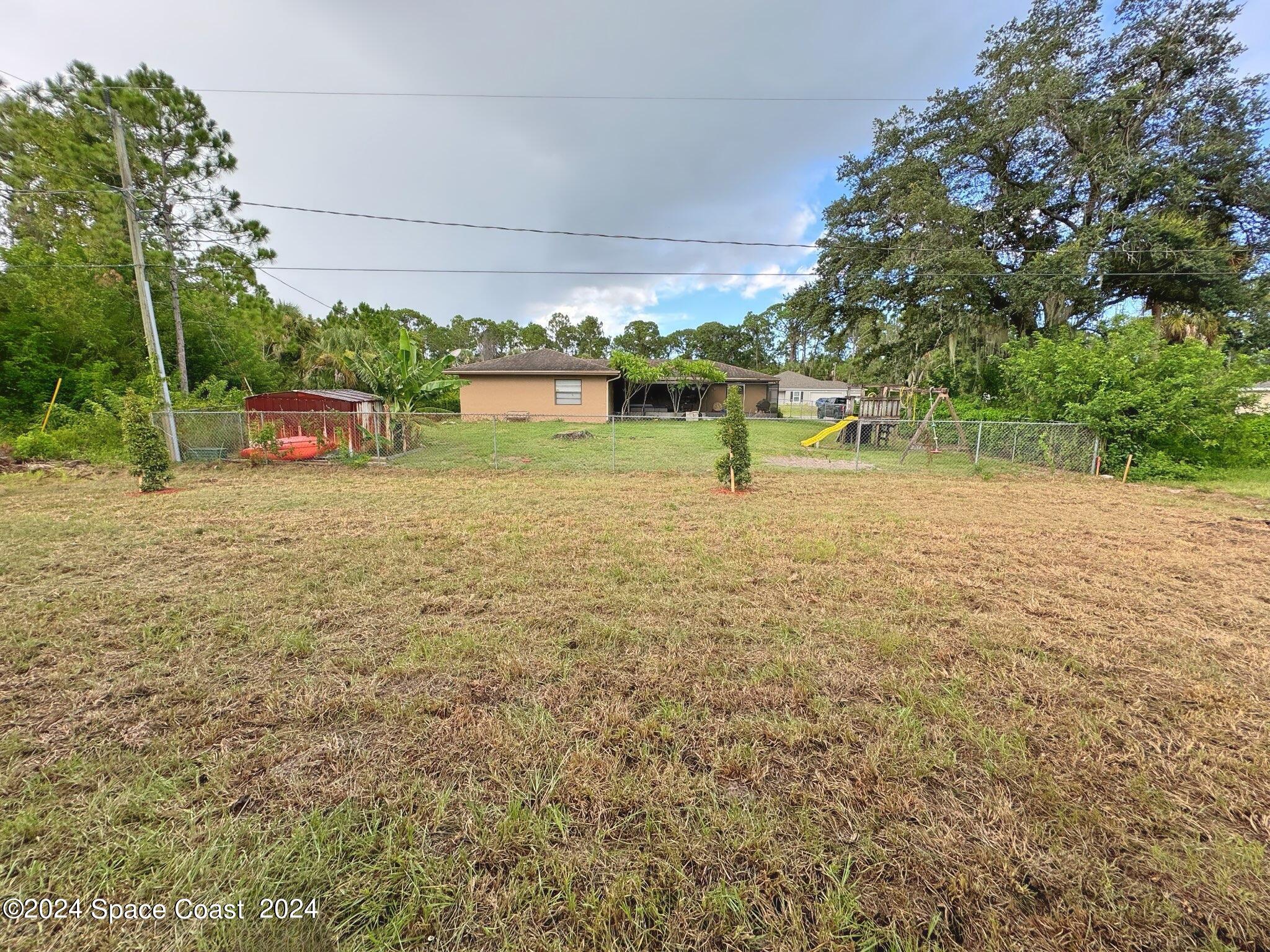435 Oakleaf Street Southwest Palm Bay, FL 32908 - Photo 18 of 44 17. 435 Oakleaf - Backyard from Patio