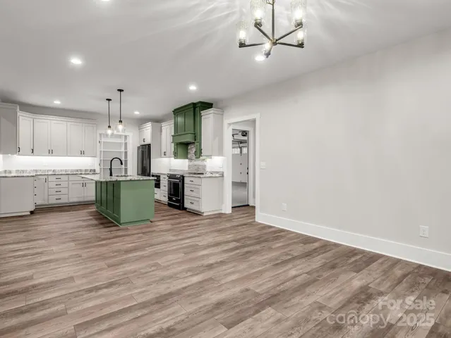 a large kitchen with a table and chairs