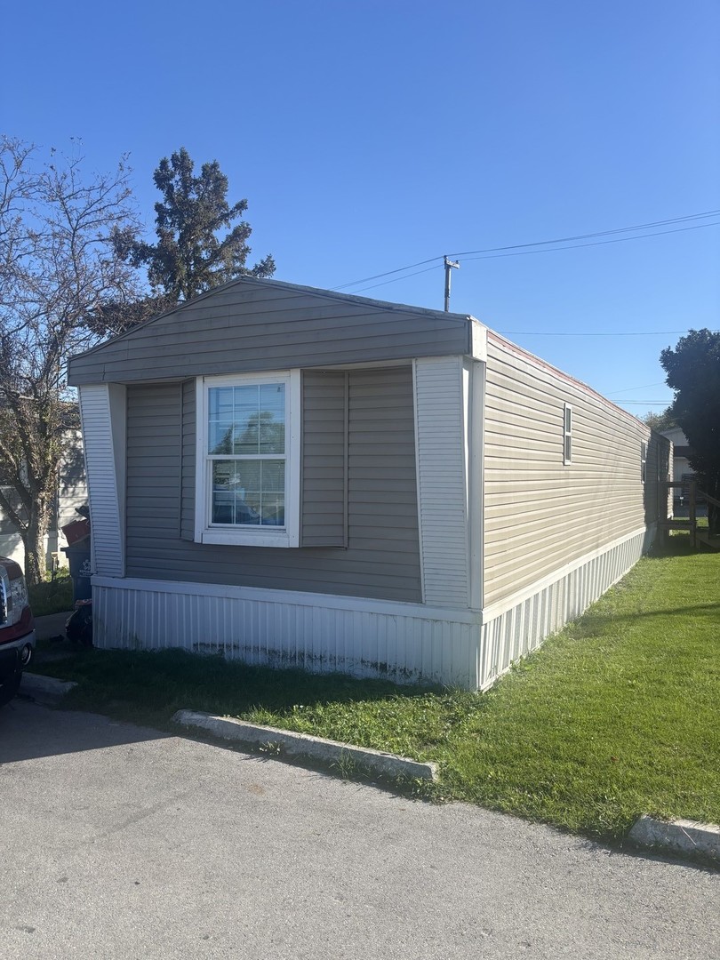 1712 South Dixie Highway, Unit 47 Crete, IL 60417 - Photo 1 of 12 a front view of a house with garden