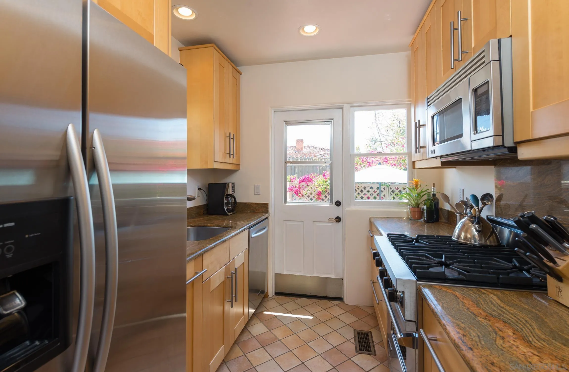 605 Arenas Street La Jolla, CA 92037 - Photo 12 of 25 a kitchen with stainless steel appliances granite countertop a refrigerator and a stove