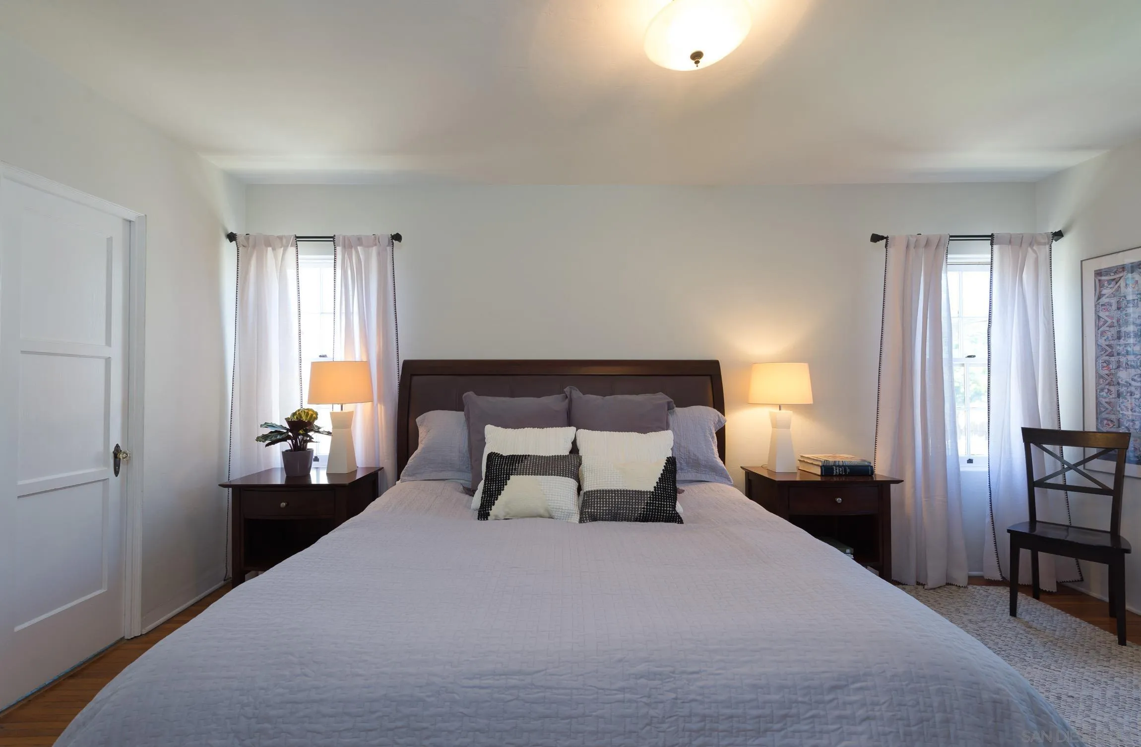 605 Arenas Street La Jolla, CA 92037 - Photo 15 of 25 a bedroom with a bed and wooden floor