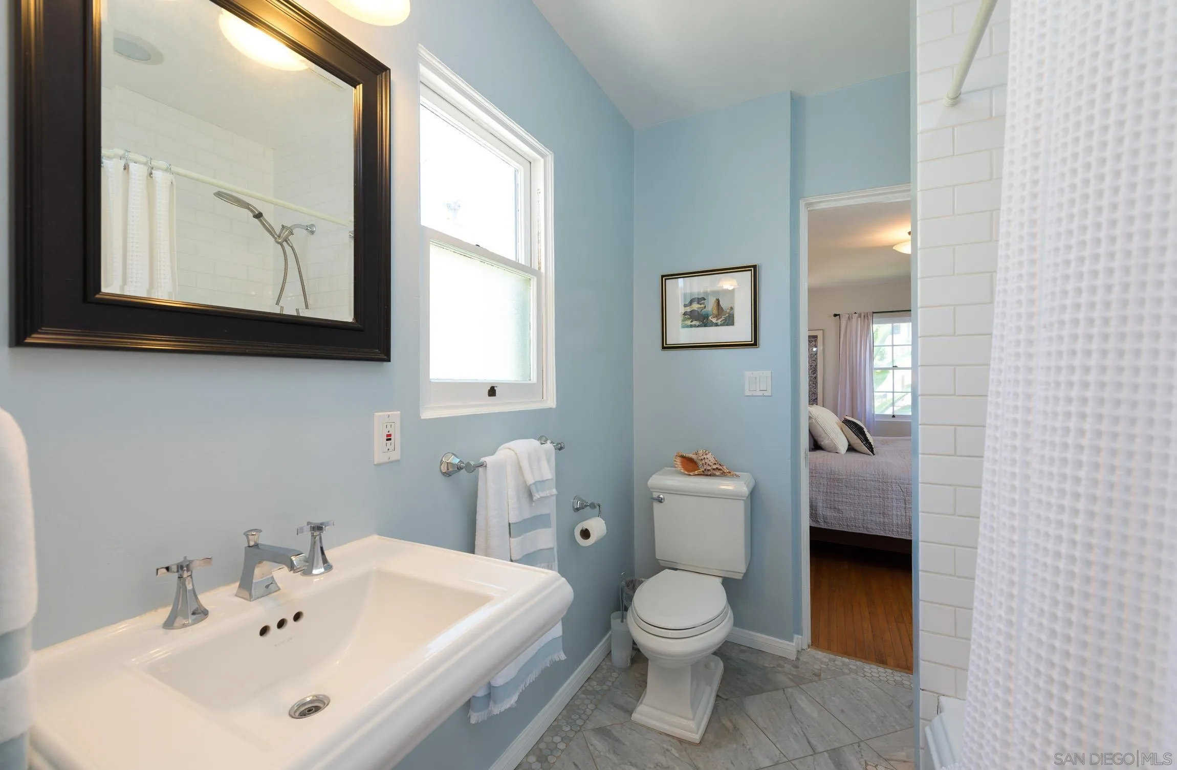 605 Arenas Street La Jolla, CA 92037 - Photo 18 of 25 a bathroom with a toilet a sink and mirror