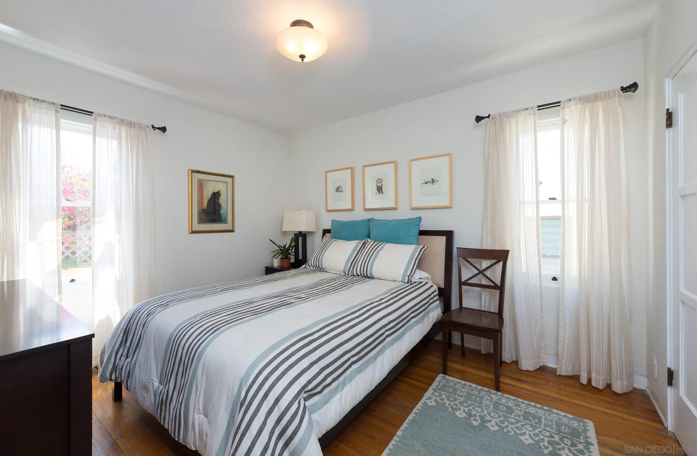 605 Arenas Street La Jolla, CA 92037 - Photo 21 of 25 a bedroom with a bed and a window