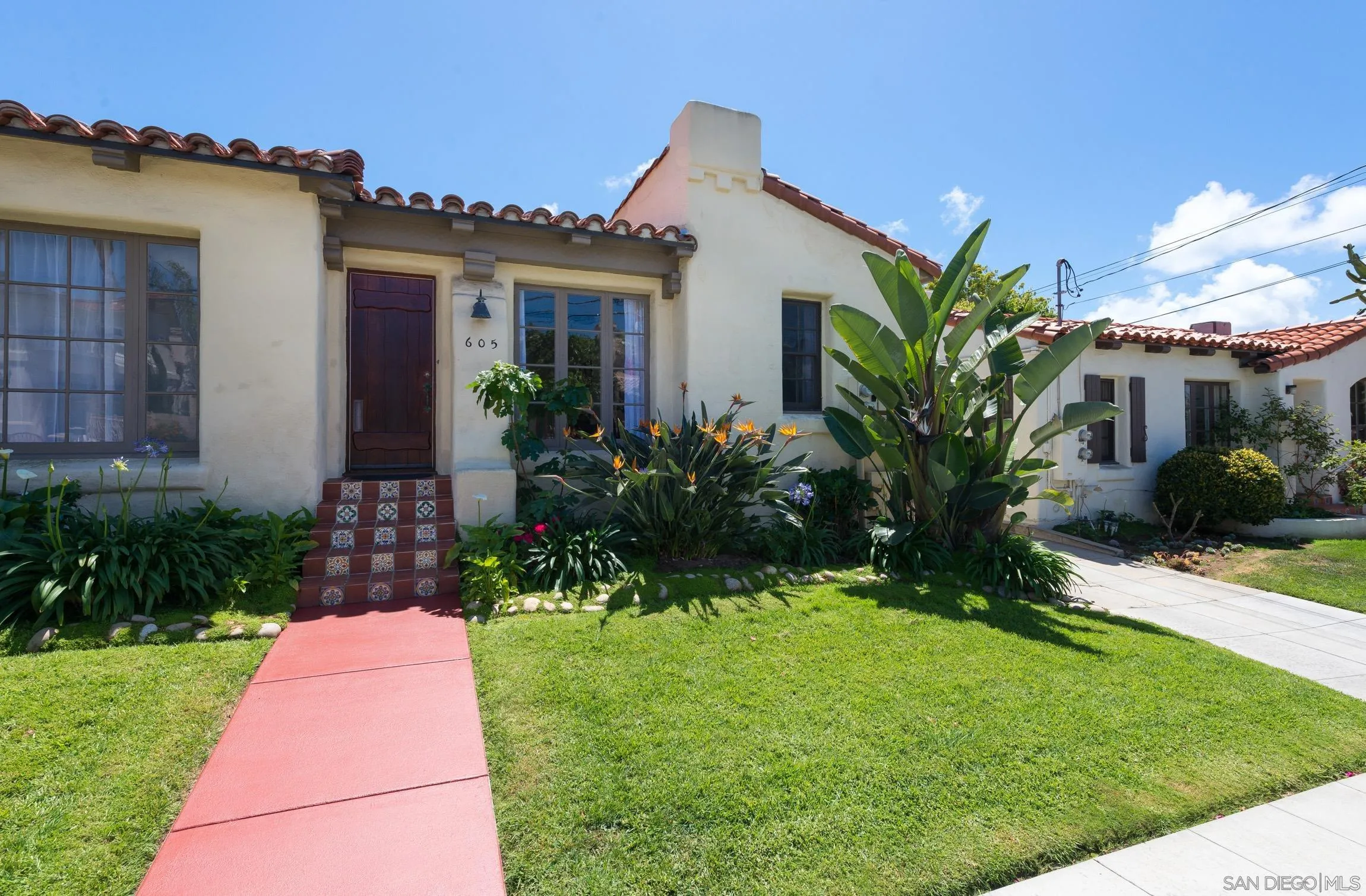 605 Arenas Street La Jolla, CA 92037 - Photo 3 of 25 a front view of a house with a garden and plants