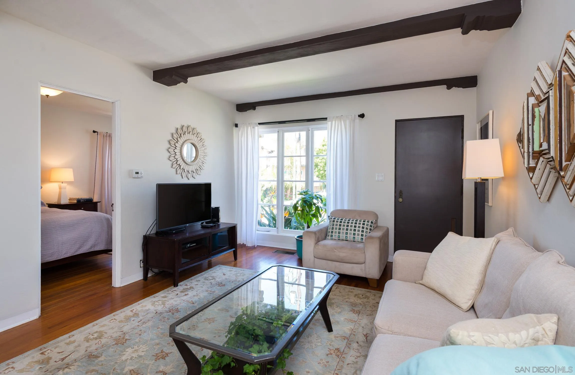 605 Arenas Street La Jolla, CA 92037 - Photo 7 of 25 a living room with furniture and a flat screen tv