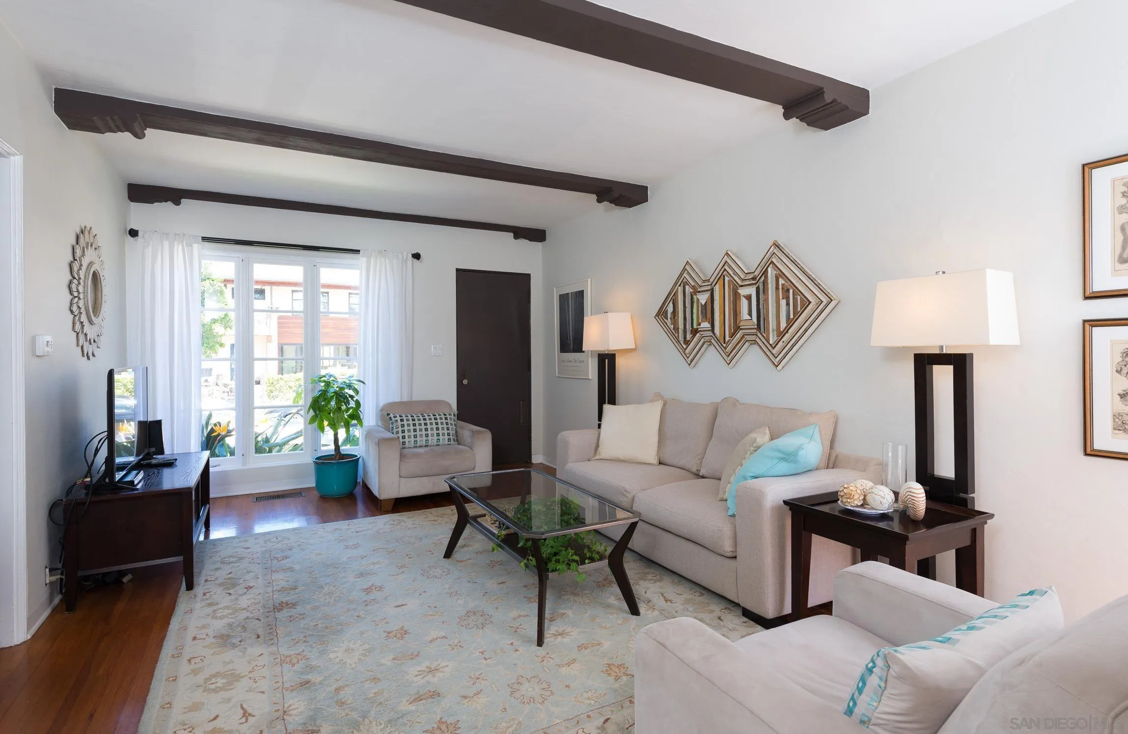 605 Arenas Street La Jolla, CA 92037 - Photo 8 of 25 a living room with furniture and a large window