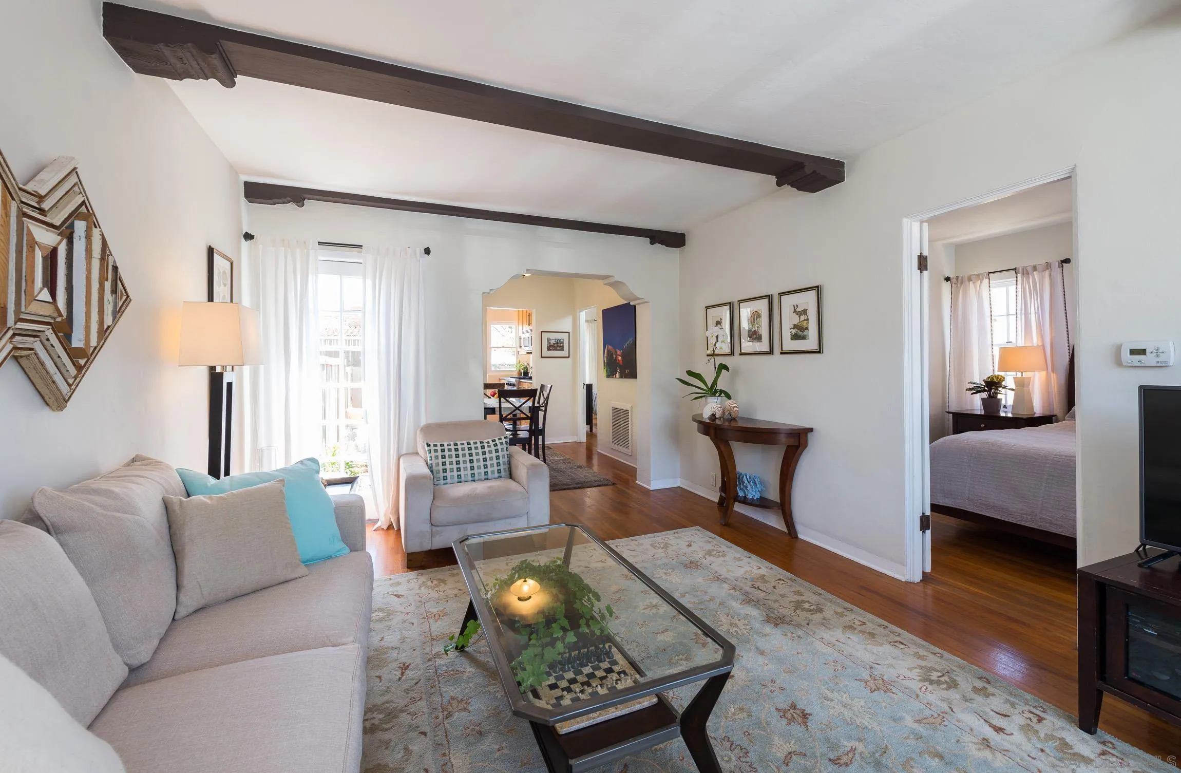 605 Arenas Street La Jolla, CA 92037 - Photo 9 of 25 a living room with furniture and a wooden floor