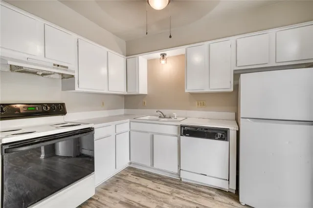 a kitchen with cabinets and stainless steel appliances