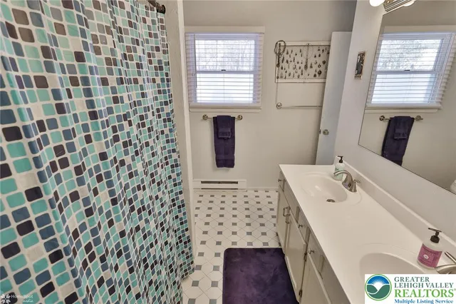 a bathroom with a toilet and a shower curtain
