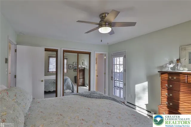 a bedroom with a large bed and a chandelier