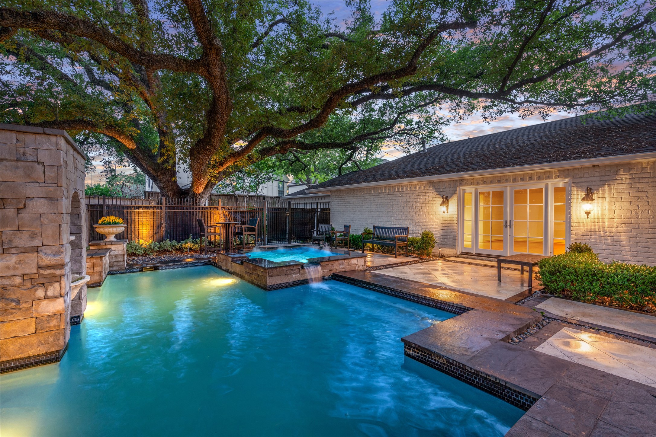 2105 Del Monte Drive Houston, TX 77019 - Photo 32 of 38 Another view of the pool and spa with the added privacy the majestic oaks provide. The master suite is through the double french doors to the right.