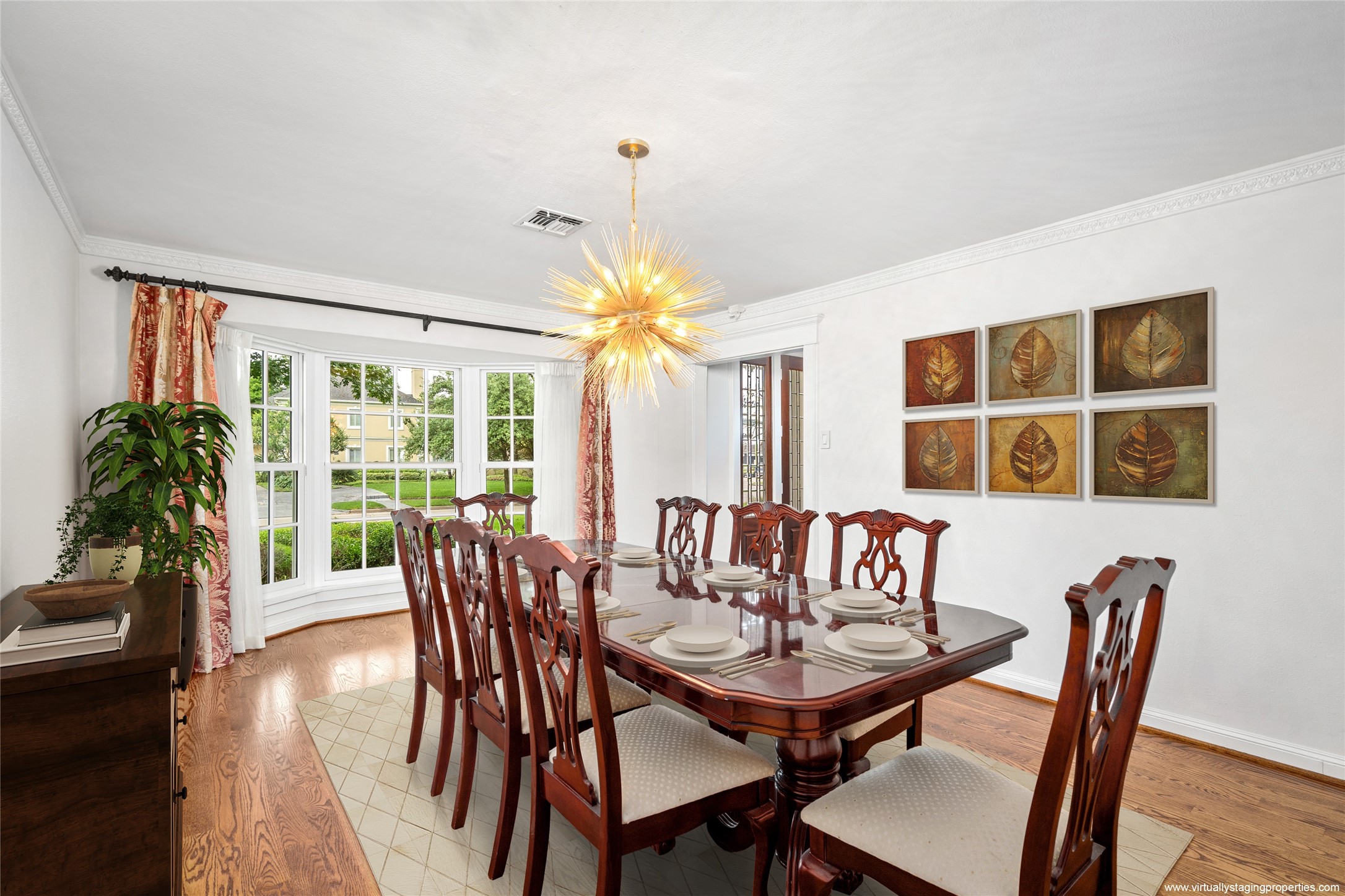 2105 Del Monte Drive Houston, TX 77019 - Photo 6 of 38 Formal dining room offers another bay window with custom drapery panels and sheers. Located just off of the entry with direct access to the kitchen. Fabulous new designer chandelier over the dining table (2023 per seller). Table and chairs can stay with the home, or will be removed -(Negotiable). Partially Virtually Staged.
