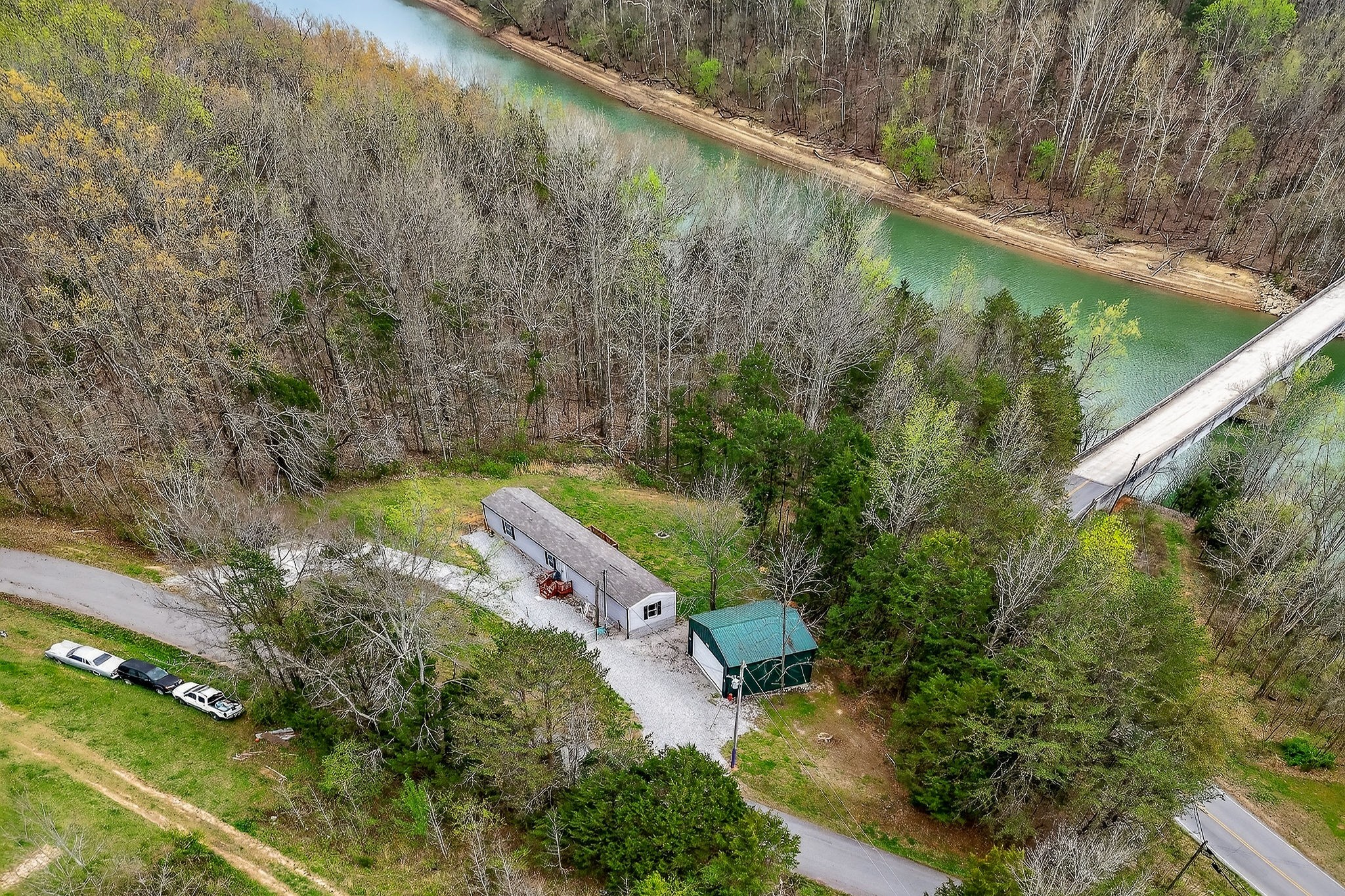 1237 Ridge Road Quebeck, TN 38579 - Photo 6 of 47 a view of a lake with a yard and large trees