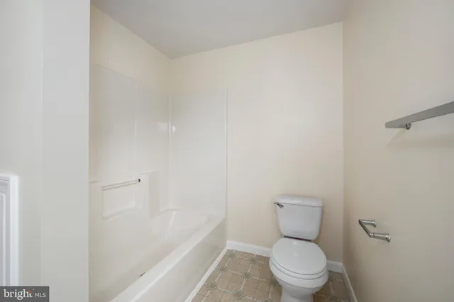 a bedroom with a bed and a bookshelf