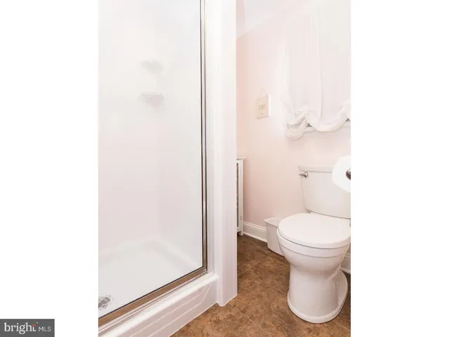 a bathroom with a toilet a sink and a mirror