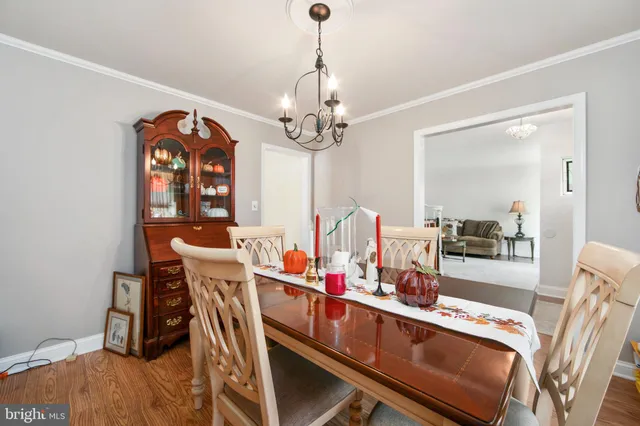 a view of a dining room with furniture and chandelier
