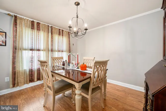 a kitchen with white cabinets and window