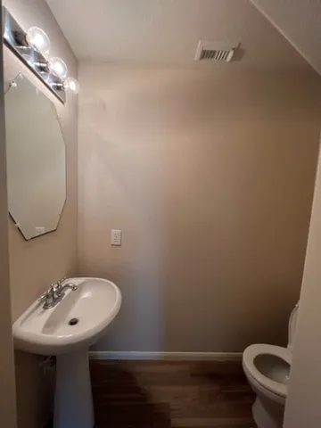a bathroom with a sink toilet and a mirror