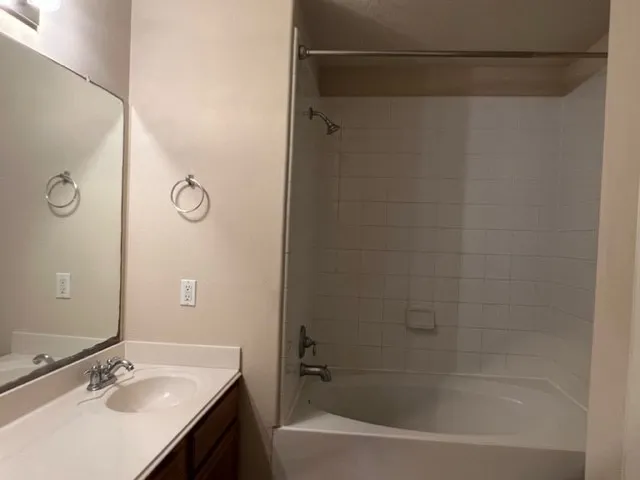 a bathroom with a shower curtain and a sink