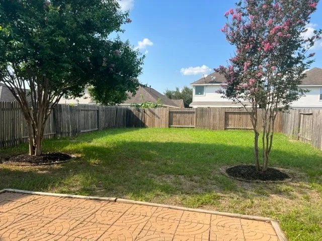 a view of a house with a yard and tree s