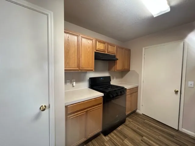 a kitchen with stainless steel appliances granite countertop a sink and a stove top oven