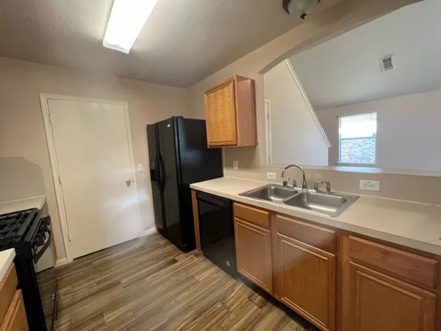 a kitchen with stainless steel appliances granite countertop a refrigerator sink and microwave