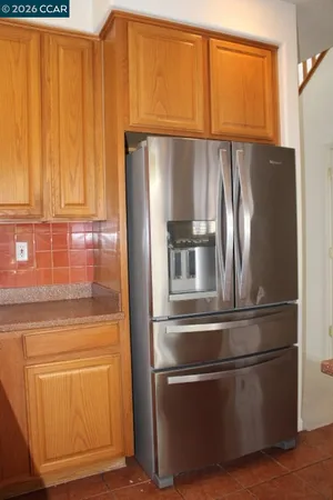 a kitchen with stainless steel appliances granite countertop a refrigerator and a cabinets