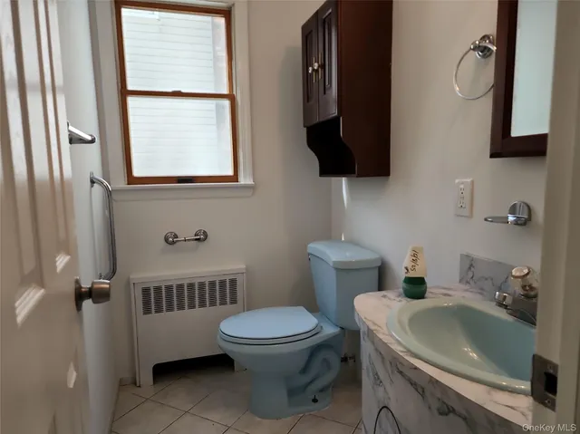 a bathroom with a toilet a sink and a mirror