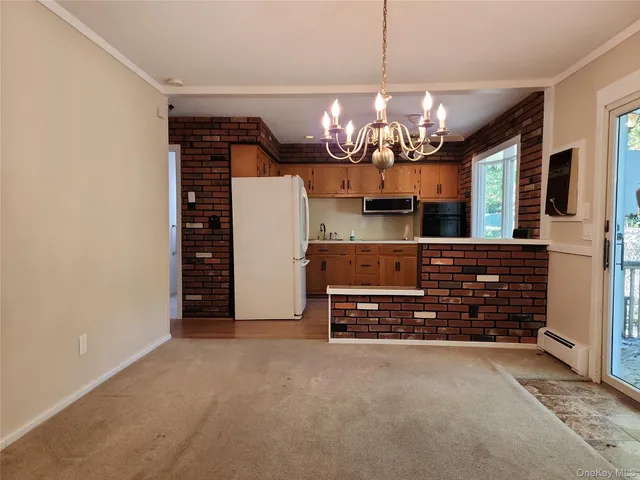 a view of a room with furniture and chandelier
